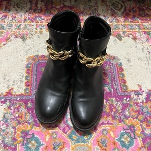 simple black booties with gold chain detail
